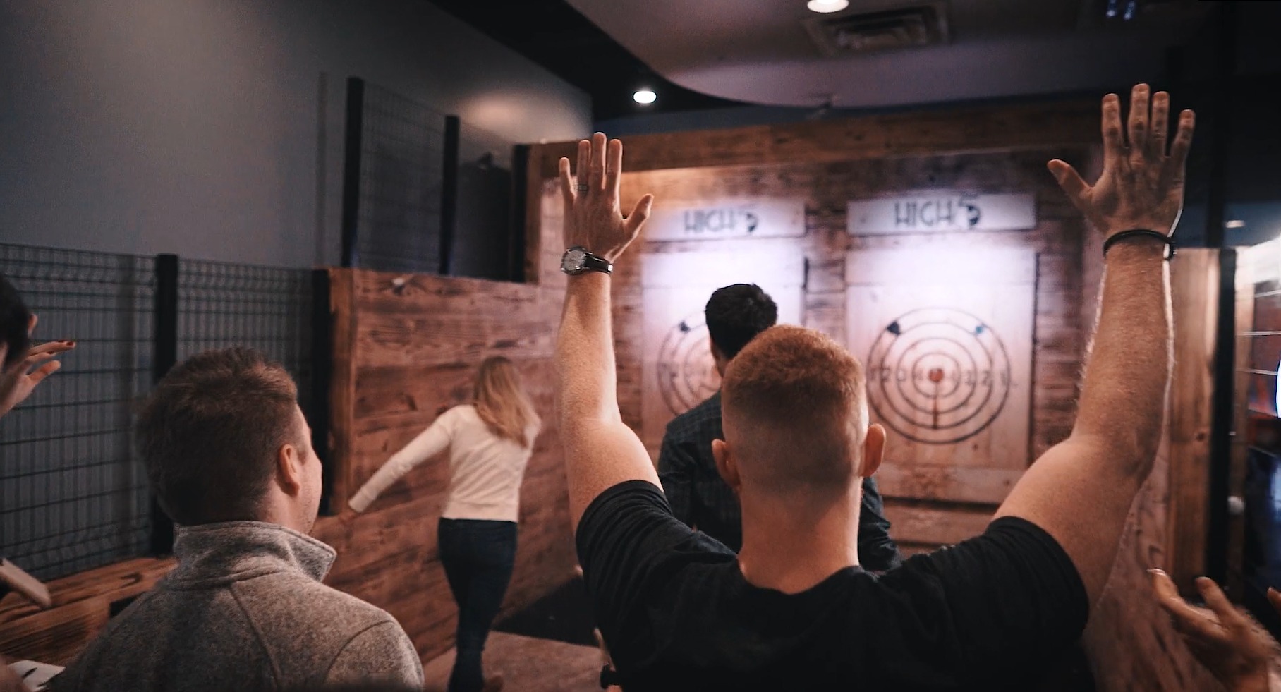 people gathered around an axe throwing venue in Austin tx at high 5 entertainment